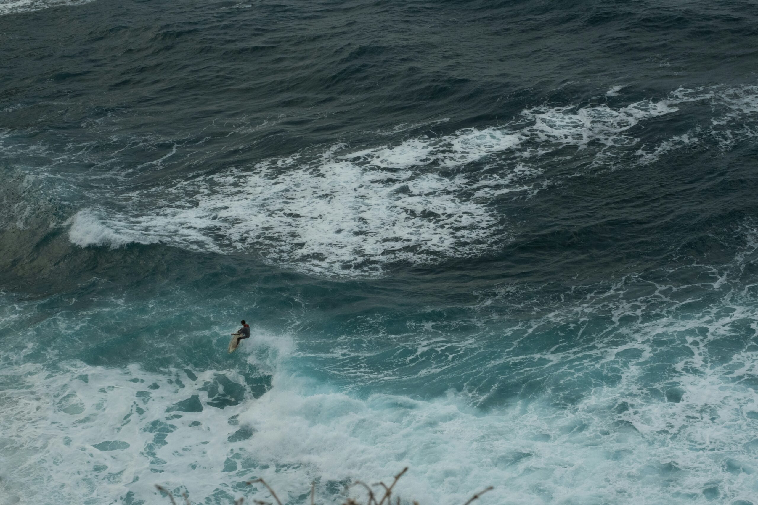 a person riding a wave on top of a surfboard